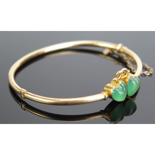 331 - A 15ct Gold and Jadeite? Hinged Bangle decorated with joined hearts, 7.9g