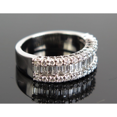 340 - An 18K White Gold and Diamond Half Eternity Ring with channel set baguette cuts and round cuts, size... 