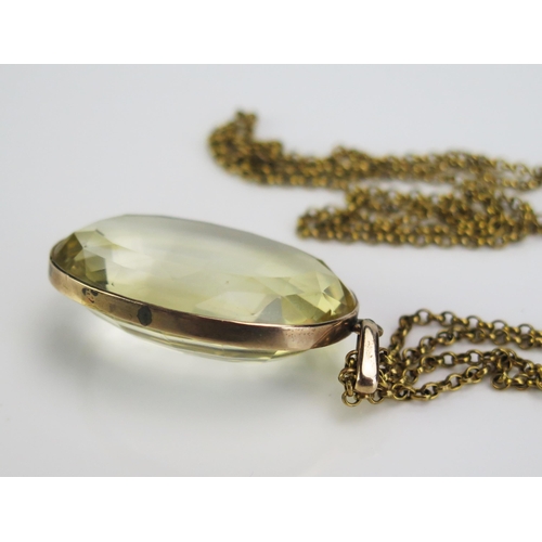 62 - A Large Citrine Pendant in a precious yellow metal surround and on a gilt belcher chain, c. 41x29mm ... 