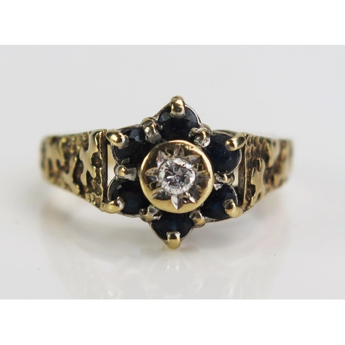 64 - A 9ct Gold, Sapphire and Diamond Cluster Ring, 11mm head, size N.5, 3.4g