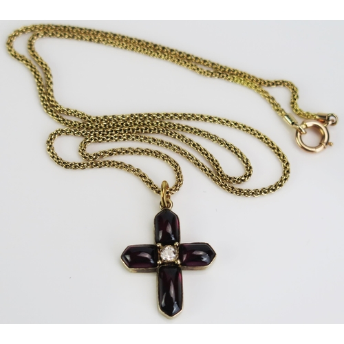 68 - A Yellow Metal Cross Pendant set with foil back cabochon garnet and an old cut diamond (c, 29mm drop... 