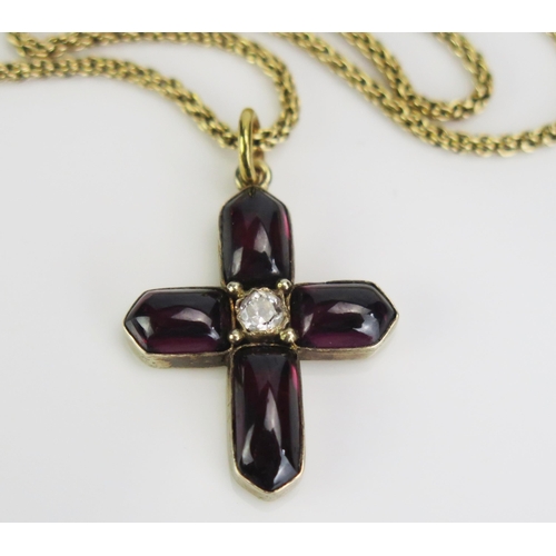 68 - A Yellow Metal Cross Pendant set with foil back cabochon garnet and an old cut diamond (c, 29mm drop... 