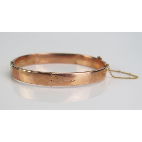 80 - A 9ct Gold Hinged Bangle engraved 