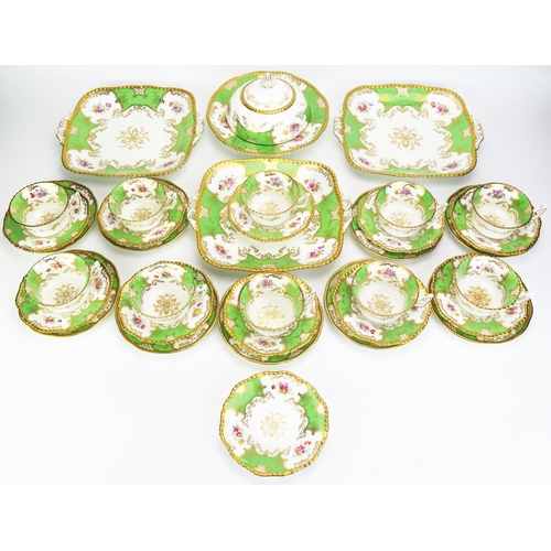 1122B - A Coalport  part tea service, including cake plates, muffin dish and cover, side plates cups and sau... 