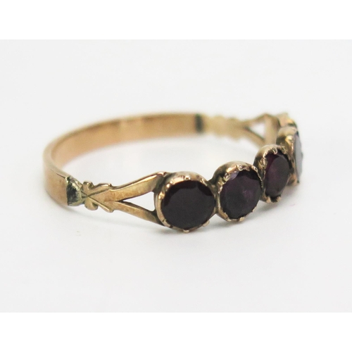 275 - A Georgian 9ct Gold and Foil Backed Garnet Ring in an unmarked precious yellow metal setting, KEE te... 