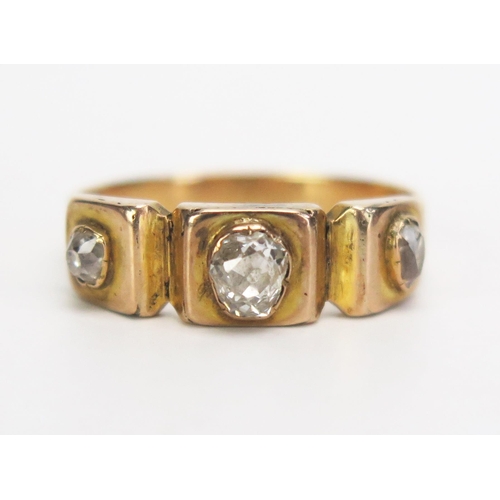 276 - A Victorian Old Cut Diamond Three Stone Ring in a precious yellow metal setting, c. 4.5x4mm central ... 