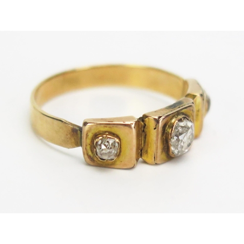 276 - A Victorian Old Cut Diamond Three Stone Ring in a precious yellow metal setting, c. 4.5x4mm central ... 