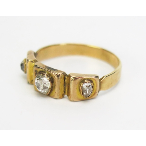 276 - A Victorian Old Cut Diamond Three Stone Ring in a precious yellow metal setting, c. 4.5x4mm central ... 