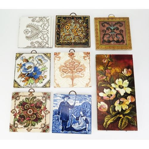 1001 - A collection of eight Victorian pottery wall tiles, including floral decorated examples and blue and... 