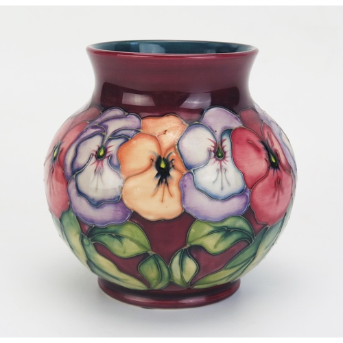 1007 - A Moorcroft pottery vase with polychrome 'Pansy' pattern decoration, by Rachel Bishop, 14cm high.