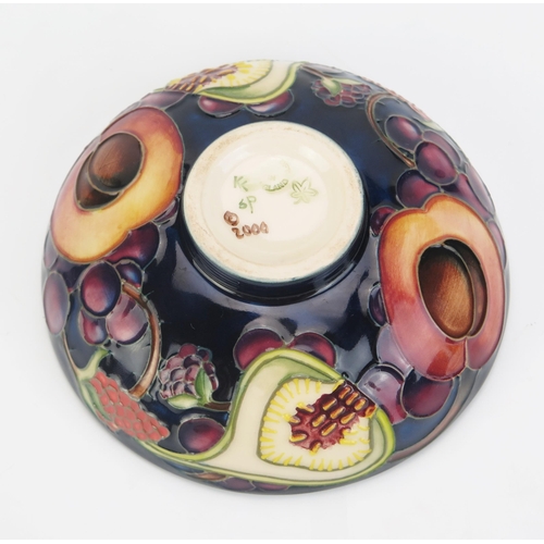 1014 - A Moorcroft pottery dish with 'Queens Choice' pattern by Emma Bossom, 12cm diameter.