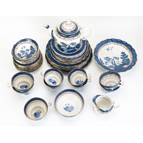 1019 - A collection of 'Ye Old Chinese Willow' pattern tea and dinner wares, including tea pot, junket set,... 