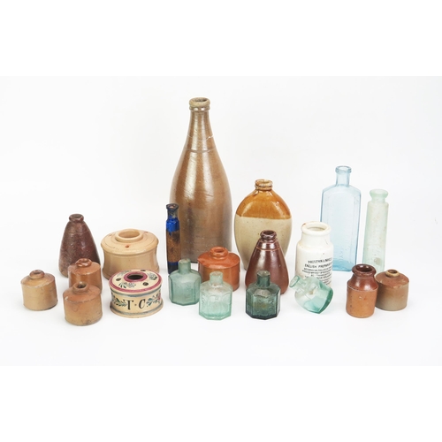 1021 - A collection of stoneware bottles, jars, inkwells. potted meat jars, glass bottles and phials includ... 