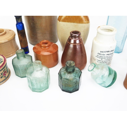 1021 - A collection of stoneware bottles, jars, inkwells. potted meat jars, glass bottles and phials includ... 