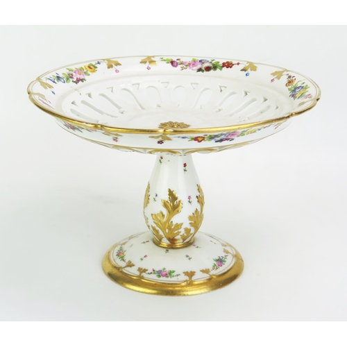 1047 - A French porcelain comport, the pierced circular dish bordered with floral garlands, raised on a bal... 