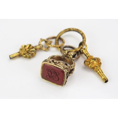 105 - A 19th Century Gilt Metal and Carnelian Seal on a gilt jump ring with two watch keys