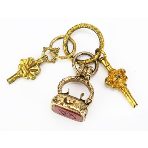 105 - A 19th Century Gilt Metal and Carnelian Seal on a gilt jump ring with two watch keys