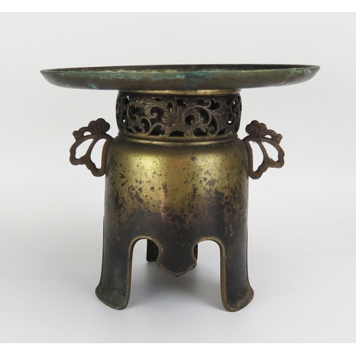 1065 - An Antique Chinese Bronze Spittoon of two parts, the base with a pierced floral scroll neck and pier... 