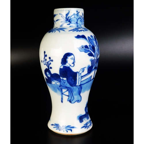 1066 - A Chinese blue and white porcelain vase of baluster form, decorated with seated figures in a garden ... 