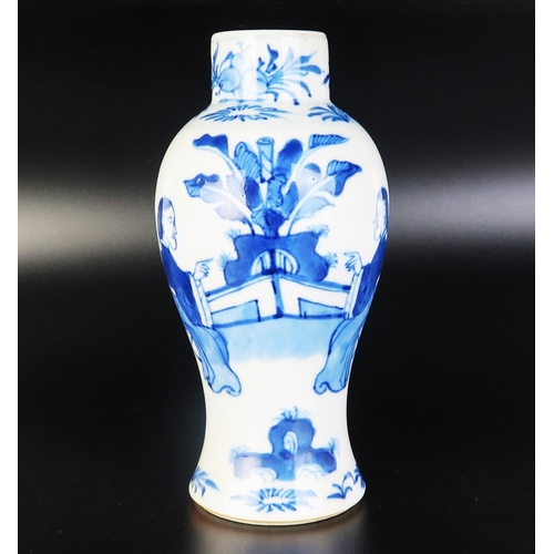 1066 - A Chinese blue and white porcelain vase of baluster form, decorated with seated figures in a garden ... 