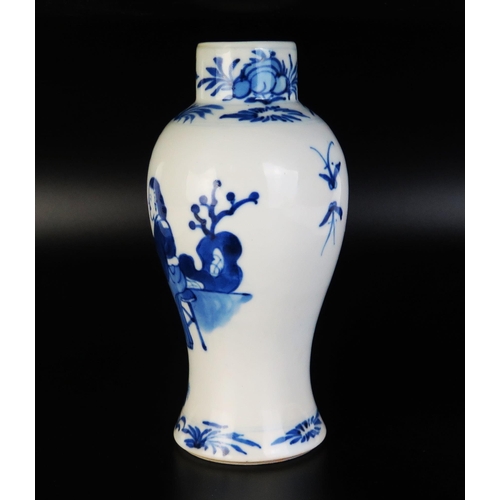 1066 - A Chinese blue and white porcelain vase of baluster form, decorated with seated figures in a garden ... 