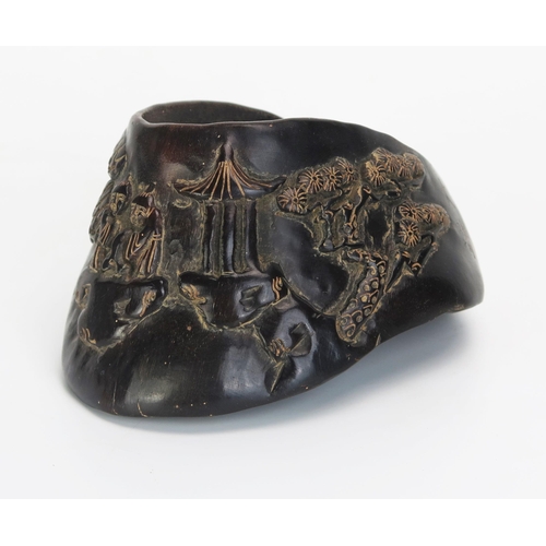 1075 - A Chinese carved horse's hoof decorated with figures in a pagoda landscape, bears six character mark... 