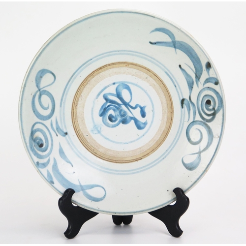 1085 - A late Ming period dish decorated with abstract swirls and scrolls, 27cm diameter.