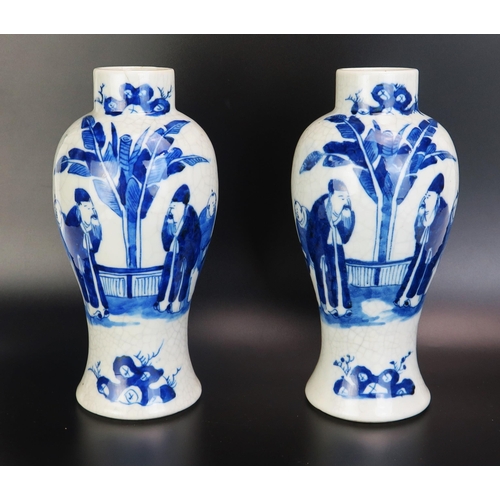 1086 - A pair of Chinese blue and white vases of ovoid form decorated with figures in a garden landscape, w... 