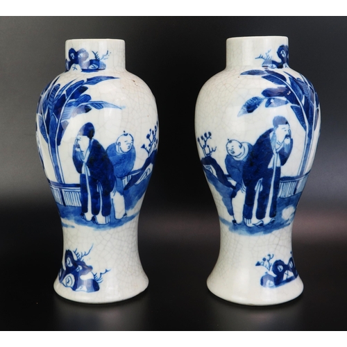 1086 - A pair of Chinese blue and white vases of ovoid form decorated with figures in a garden landscape, w... 