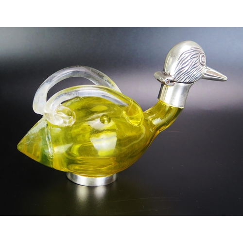 1093 - A yellow glass and silver plate mounted  oil bottle in the form of a duck with hinged head with loop... 