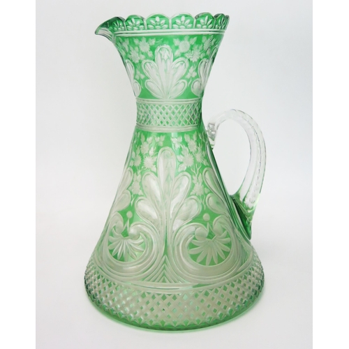 1095 - A late Victorian green glass cordial jug by Stevens & Williams, Stourbridge, of waisted form with et...