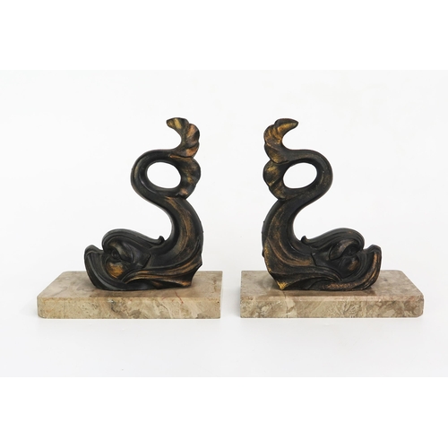 1103 - A pair of bronzed metal bookends, modelled in the form of dolphins, mounted on rectangular polished ... 