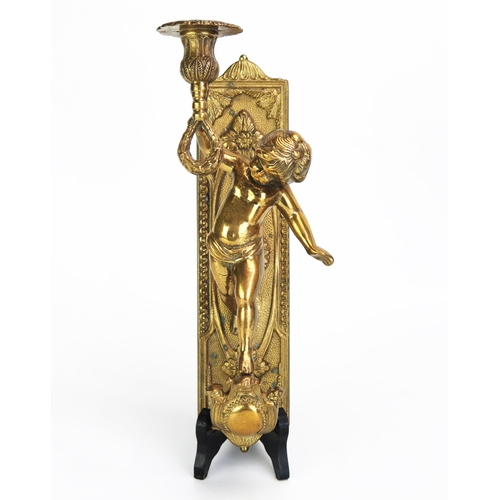 1104 - A gilt brass wall applique, with a single putto holding a candlestick with foliate decorated sconce,... 