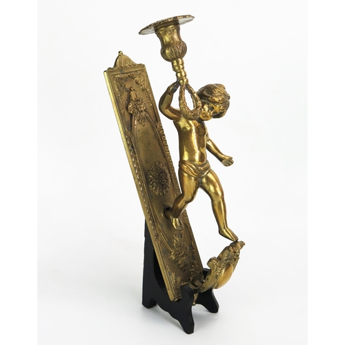 1104 - A gilt brass wall applique, with a single putto holding a candlestick with foliate decorated sconce,... 