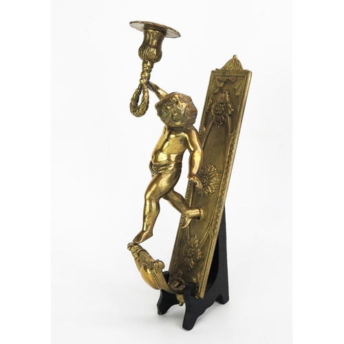 1104 - A gilt brass wall applique, with a single putto holding a candlestick with foliate decorated sconce,... 