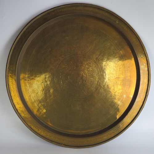 1110 - A Benares brass circular tray or tiffin table top, decorated with elephant, birds and animals, 72cm ... 