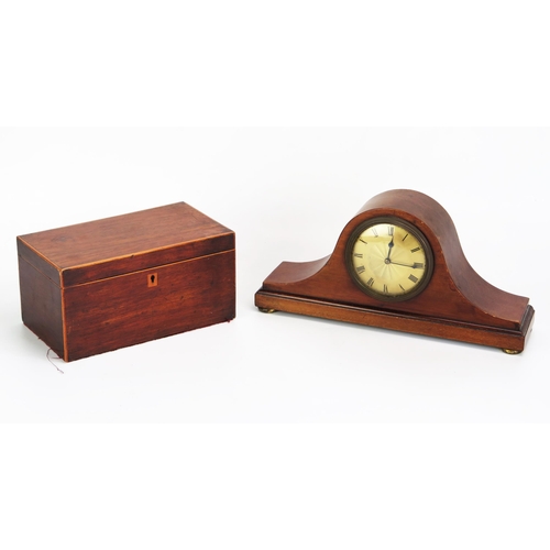 1115A - An Edwardian mahogany mantel timepiece of arched outline, with 9cm Roman dial, raised on squat gilt ... 