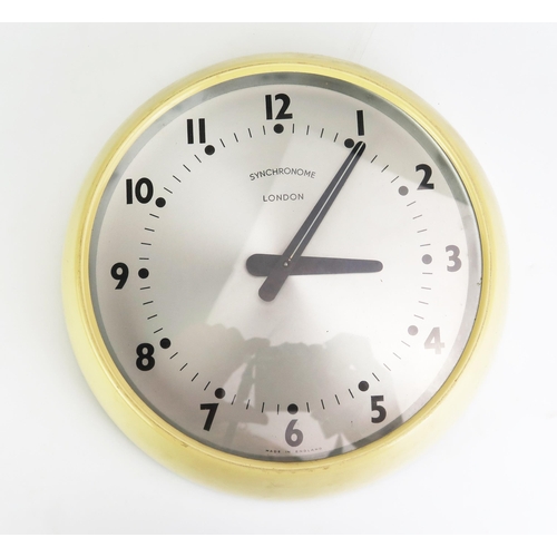 1140 - A Synchronome electric wall with 21cm Arabic dial contained in a cream painted circular frame.