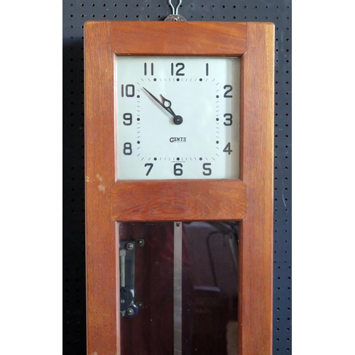 1145 - A GENTS master clock contained in an oak case, with pendulum, 127cm high