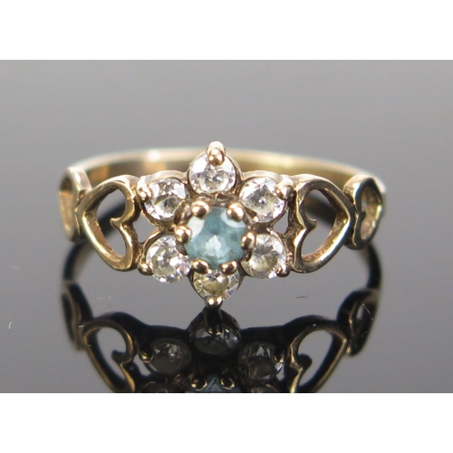 115 - A Modern 9ct Gold Flower Head Cluster Ring with blue tourmaline? and white stones, hallmarked, size ... 