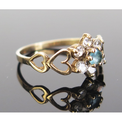 115 - A Modern 9ct Gold Flower Head Cluster Ring with blue tourmaline? and white stones, hallmarked, size ... 