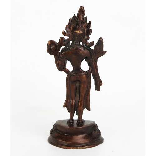 1150 - A bronze Buddhist statue of a female deity, inset with coral, standing on a lotus flower base, 16.5c... 