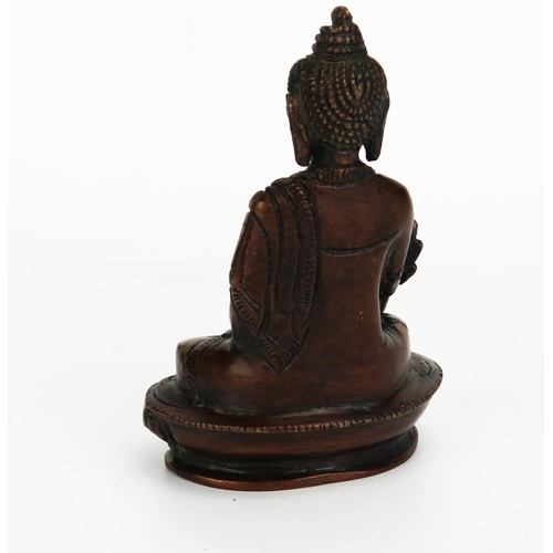 1151 - A bronze model of Buddha, seated crossed legged on a lotus flower, 14cm high.