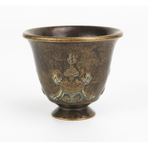 1154 - A bronze Buddhist temple goblet, of inverted bell-shape, on a circular foot, 4.5cm high.