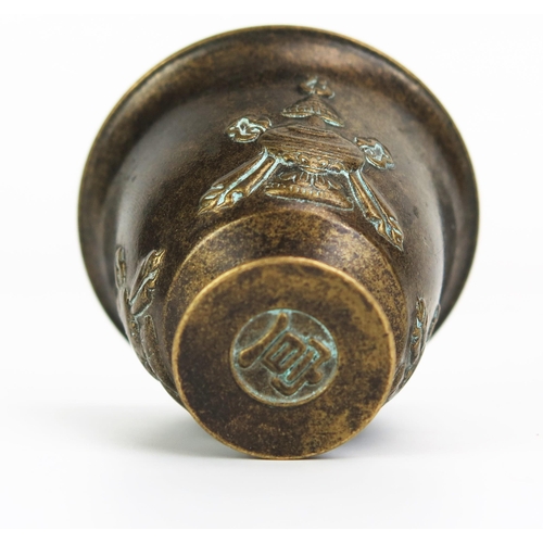 1154 - A bronze Buddhist temple goblet, of inverted bell-shape, on a circular foot, 4.5cm high.