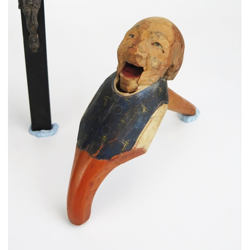 1156 - A German carved wooden figural nutcracker, a crucifix and figural bottle opener