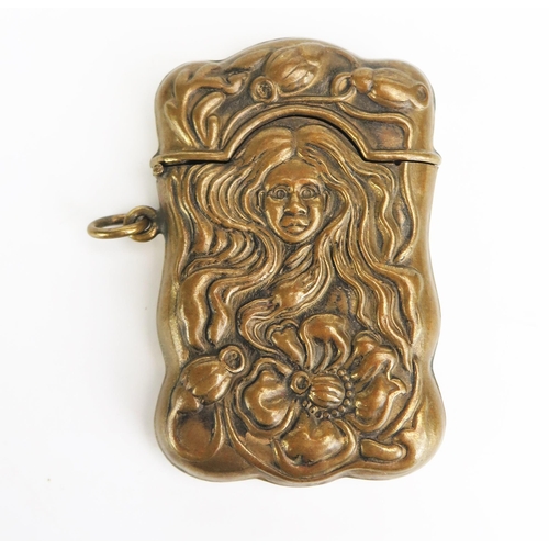 1179 - A reproduction pressed brass vesta case, of Art Nouveau influence, 6.5cm long.