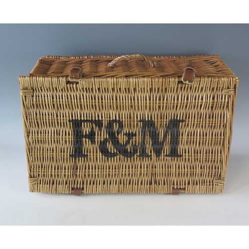 1181 - A Fortnum & Mason wicker hamper, with leather hinges, stencilled F & M to the hinged lid, 50cm wide.