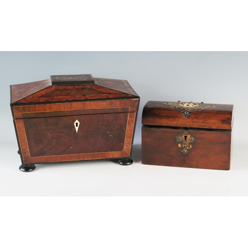 1184 - A Victorian walnut and brass mounted tea caddy, the domed hinged lid enclosing two lidded compartmen... 