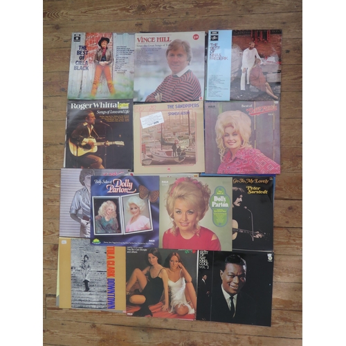 1220 - A collection of fourteen 33rpm and 45 rpm records by various artists including Abba, Dolly Parton, C... 